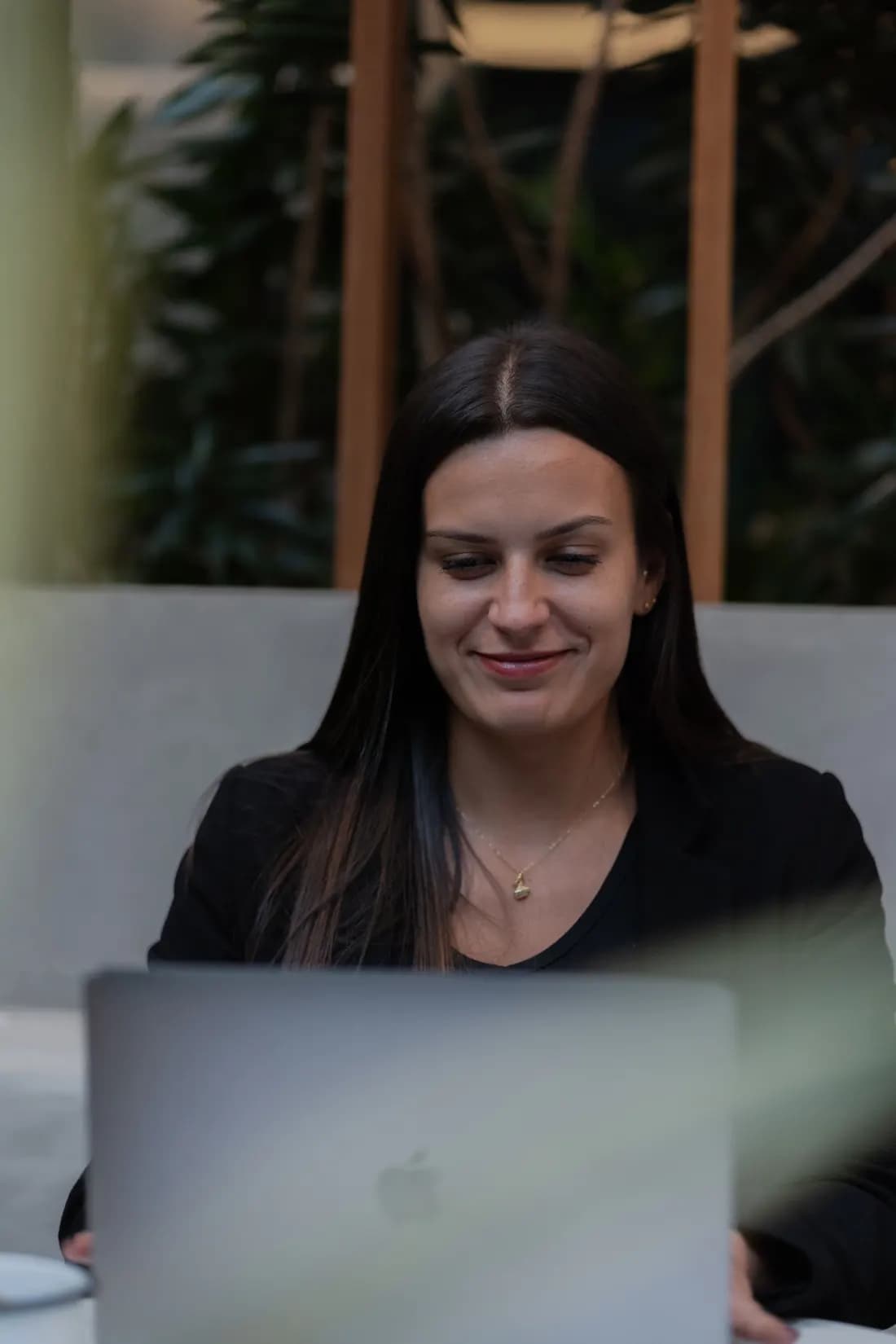Woman working on her laptop at a bright office desk
